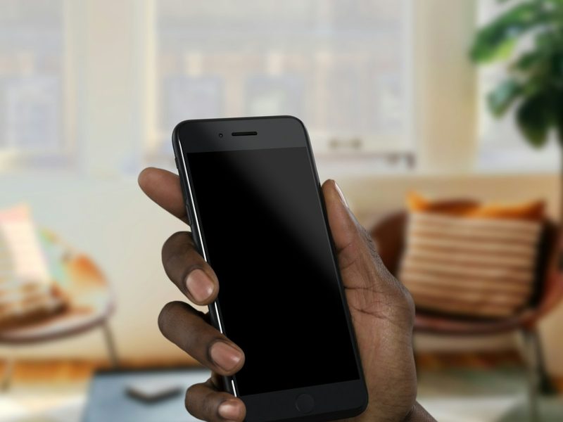A phone held in a sunlit room.