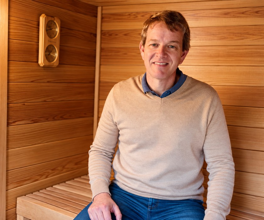 Jonathan Bricker in the backyard Finnish sauna he built with family and friends.